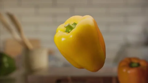 Yellow bell pepper jumping in slow motion Stock Footage 152903409