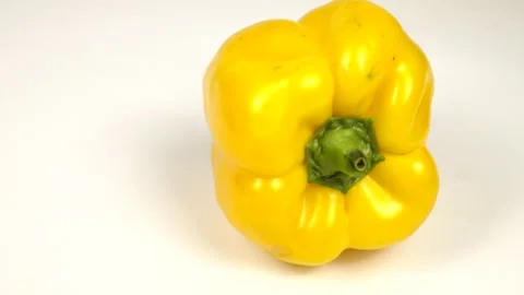 Yellow bell pepper is on a white board, top part of sweet pepper Stock Footage 319832562