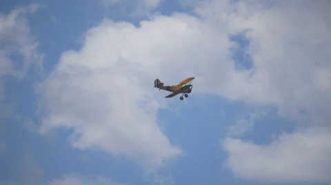 YELLOW BI PLANE FLYING CLOUDS Stock Footage 29989776