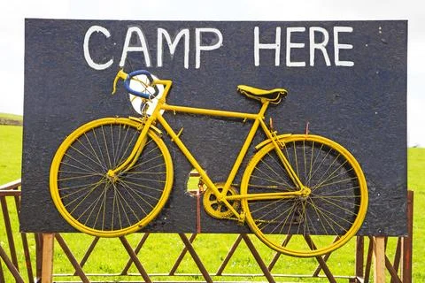 A Yellow Bicycle on a Display Board Stock Photos