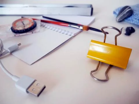 Yellow binder, compass and notepad on a trip on a white table Stock Photos