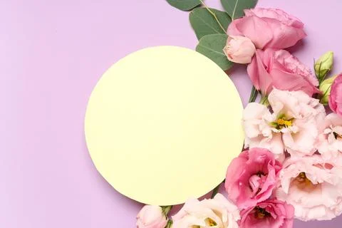 Yellow blank card in shape of circle with beautiful flowers on purple backgro Stock Photos