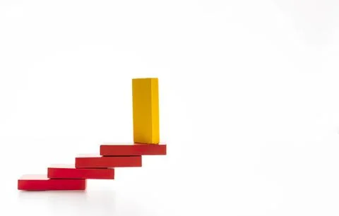 Yellow block standing on red steps increasing in size Stock Photos