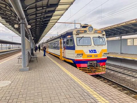 Yellow-blue train at a train station, possibly Ukraine Railways Passengers .. Stock Photos