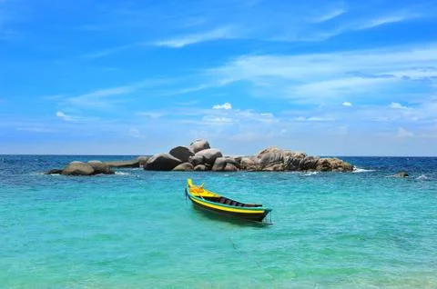 Yellow boat in the turquoise sea Stock Photos