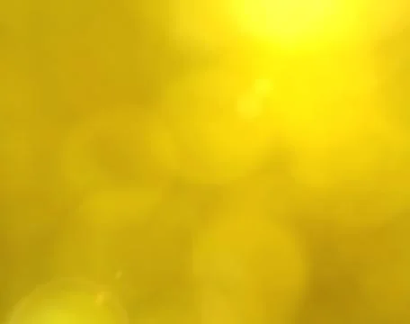 Yellow bokeh background with lens flare effect Stock Photos