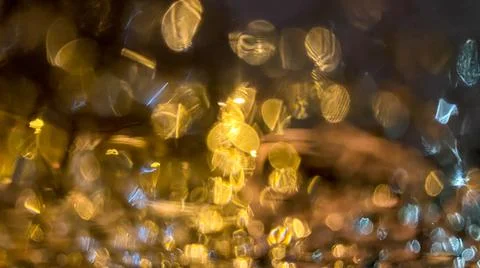 Yellow bokeh effect in night or evening street lighting on car glass in frost Stock Photos