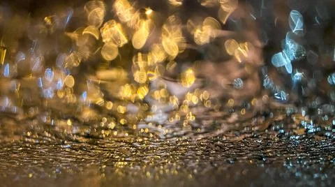 Yellow bokeh effect in night or evening street lighting on car glass in frost Stock Photos