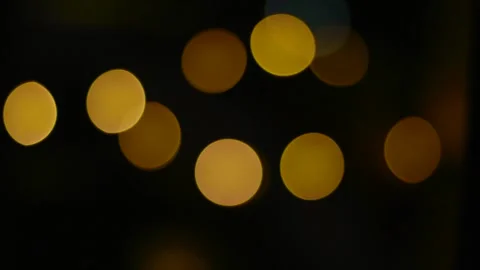 Yellow bokeh in the form of circles. Shining city lights. Stock Footage 236418054