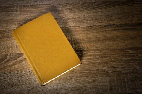 Yellow book on the table Stock Photos