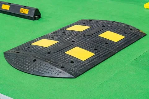 Yellow-bordered rectangular object with holes on a green background, position 스톡 사진