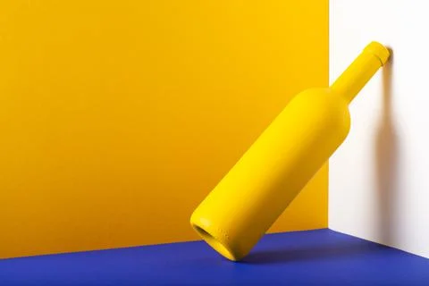 Yellow bottle on the blue table. 库存照片