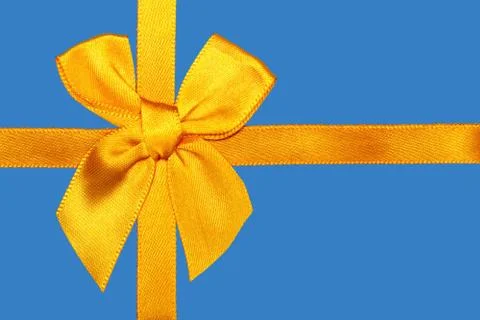 Yellow bow on blue background Stock-Fotos