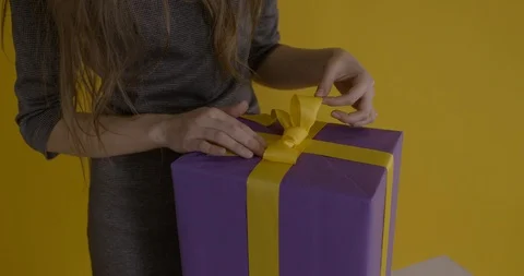 Yellow bow on a gift package Stock Footage 125426260