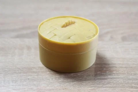Yellow box with a squishy dumpling on a light background Foto stock