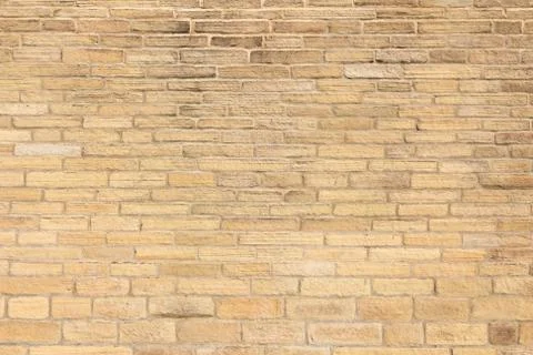 Yellow brick wall background - architectural surface texture. Stock Photos