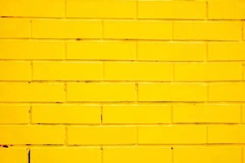 Yellow brick wall as a background Stock Photos