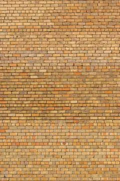 Yellow brick wall as background Stock Photos