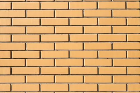 Yellow brick wall background texture, full frame. Modern new brick. Stock-Fotos