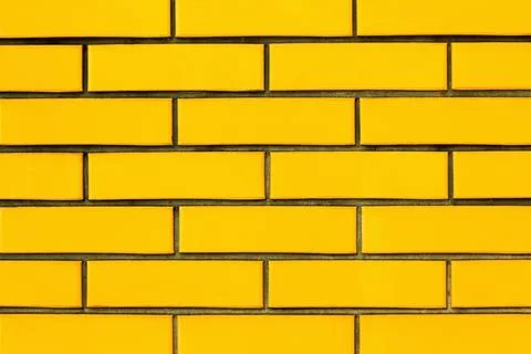 Yellow brick wall texture background. Brickwork. Brick facade of the building Stock Photos