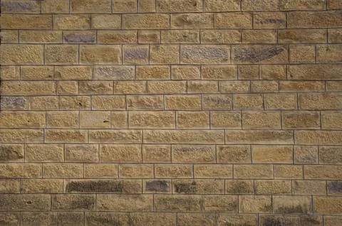 Yellow brick wall texture Stock Photos