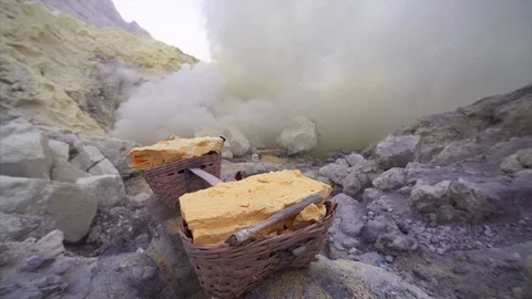 Yellow bricks of sulphur in backets that is obtained from Ijen volcano.East Java Stock Footage 113898134