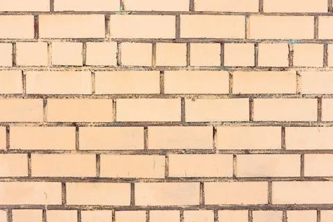 Yellow brickwork background. Brick wall painted with yellow paint. Stock Photos