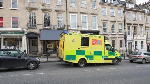 Yellow British UK ambulance nhs ambulance, urgency Stock Footage
