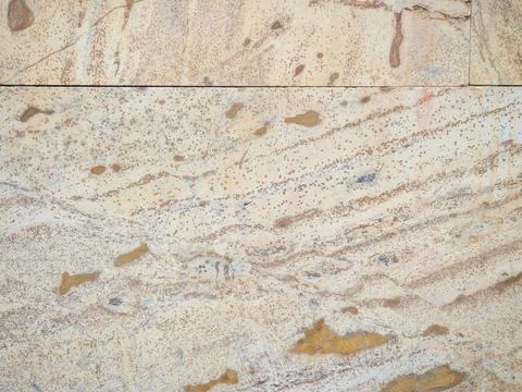 Yellow-brown material. Church cladding. Background from stone tiles. Interest Stock Photos