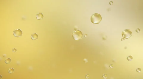 Yellow bubble adhered to the glass of water Stock Footage
