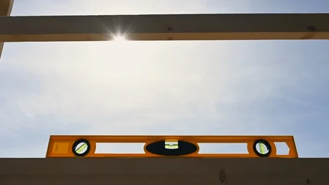 Yellow bubble level checking wooden construction sky background Stock Footage 108063871