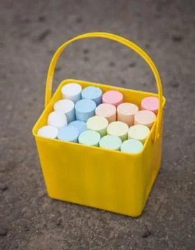 Yellow bucket with chalks Stock Photos