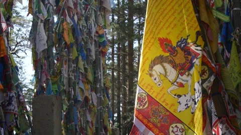 A yellow Buddhist prayer flag flutters in the light breeze. Stock-Footage 284047559
