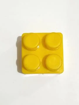 Yellow Building Block with Four Studs on White Background. Stock Photos