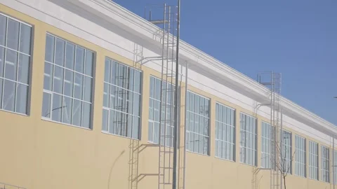 Yellow building with windows, blue sky Stock Footage 285133792
