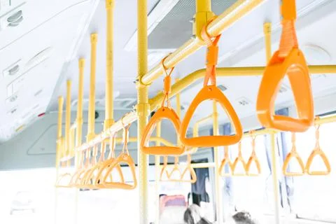 Yellow bus handle on ceiling for standing passenger, public transportation tr Photos