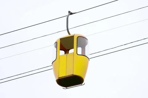 Yellow cab of the cable car at the height. Stock Photos