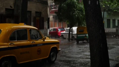 Yellow Cab Moving Away in Rain, Slow Motion, HD Stock Footage 82979603