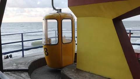 The yellow cabin of the cable car drives up to the place of boarding passengers Stock Footage 202072166
