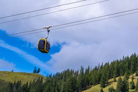 Yellow Cable Car Over Alpine Forest Stock Photos