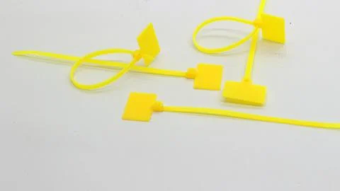 Yellow cable ties with markings isolated Stock Photos