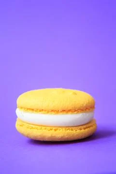 Yellow Cake macaron or macaroon on purple background. 写真素材
