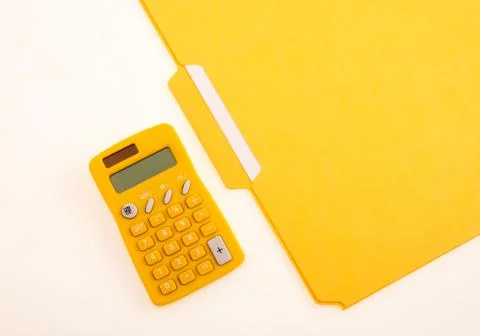 Yellow Calculator and Folder Stock Photos