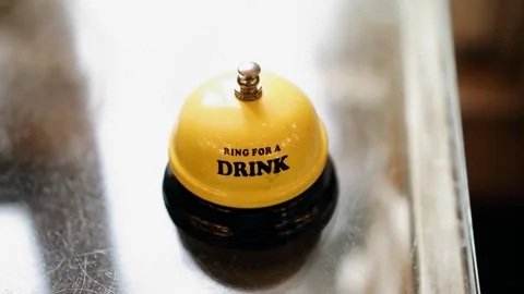 A yellow call bell at the reception with "COFFEE" written on it Stock Footage 315350704