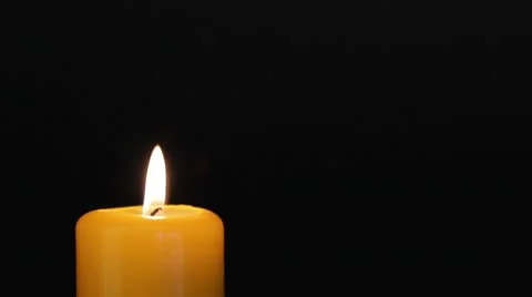 Yellow candle on the dark Stock Footage 10565767
