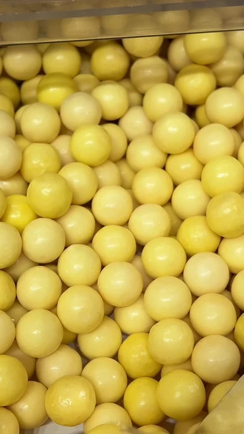 Yellow candy scoop Spoon gathers vibrant sprinkles in close-up view Stock Footage 316076880