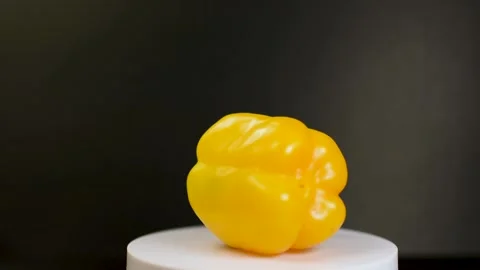 Yellow Capsicum rotating with black background Stock Footage 233684677