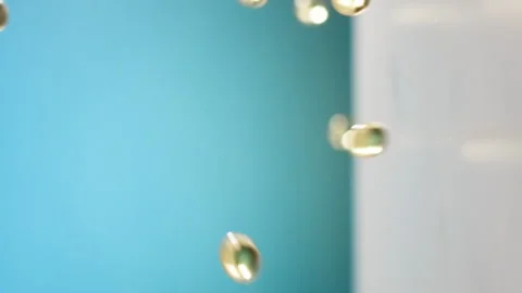 Yellow capsule balls fall down Stock Footage 269767988