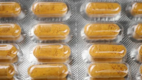 Yellow capsule in blister pack close up, slider shot Video stock 220795184