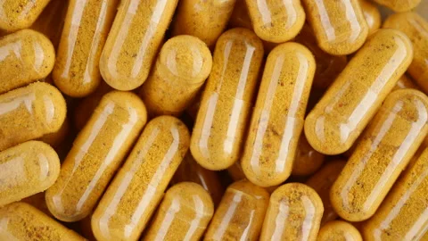 Yellow capsule top view, rotation. Tablets or vitamins in capsules Stock Footage 220794804